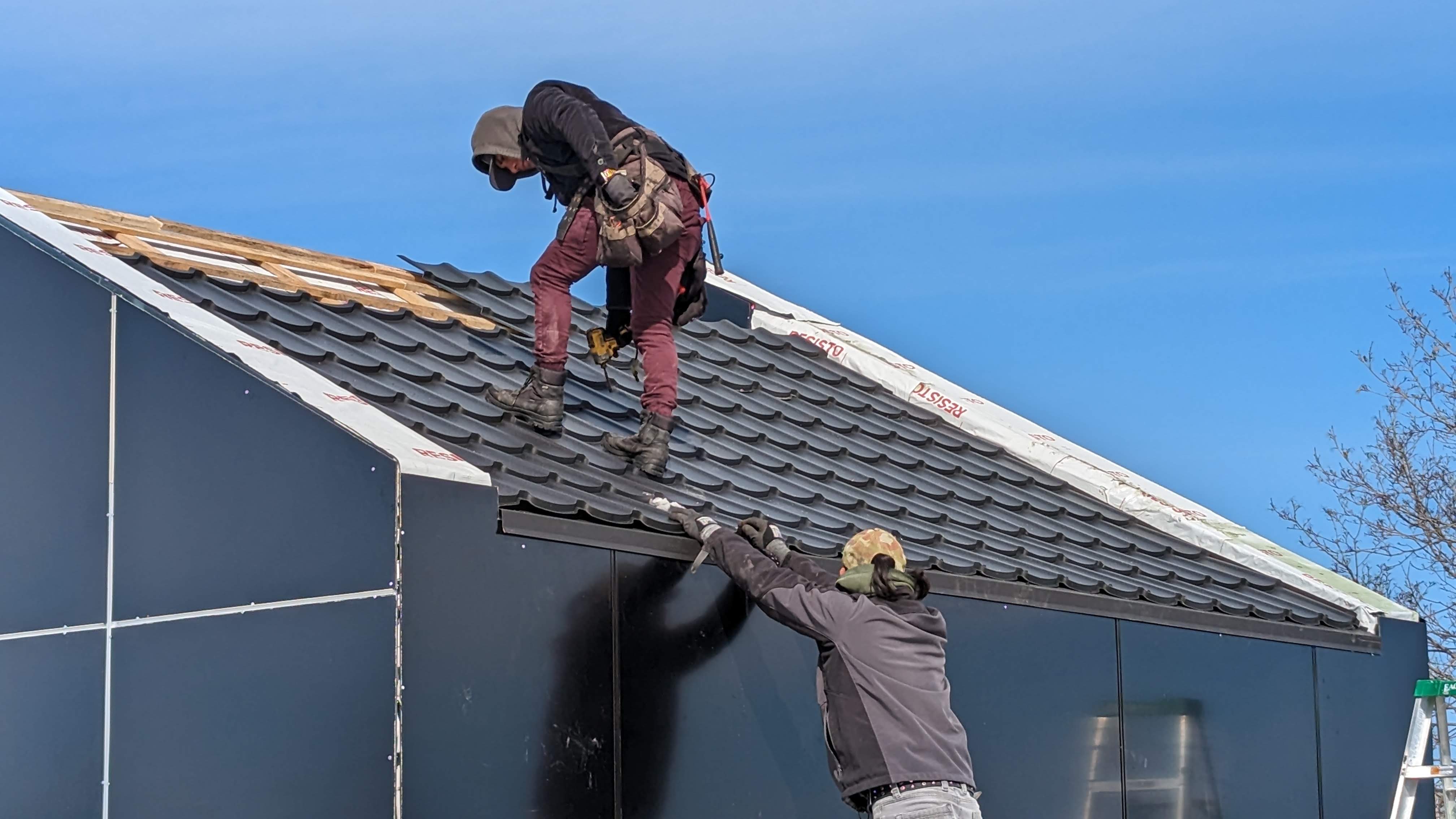We Metal Roof crew installing metal shingles on a residential roof