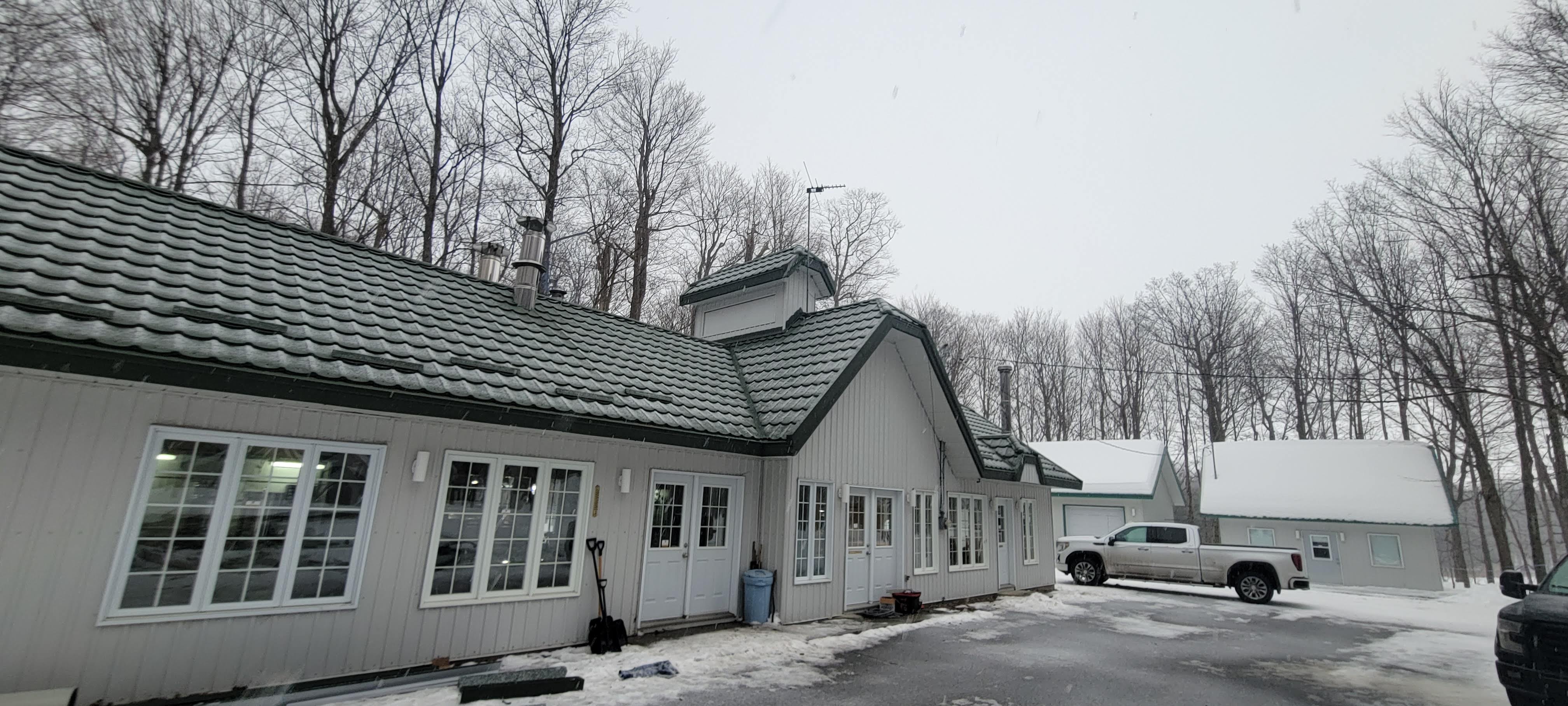 Completed metal tile roof on a large residential building in winter
