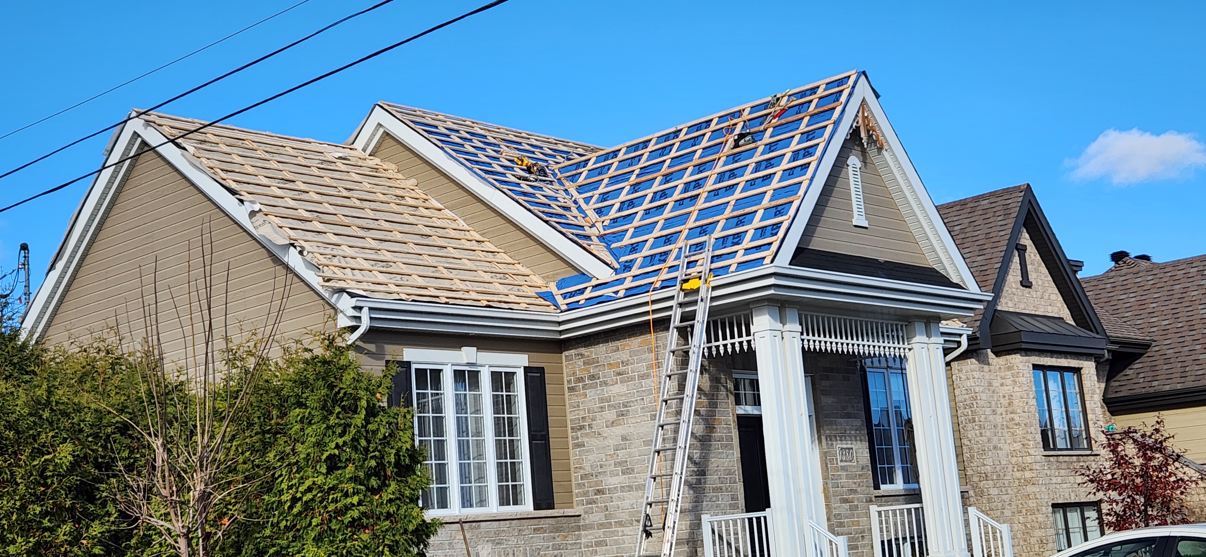 Metal roof installation in progress on a residential home