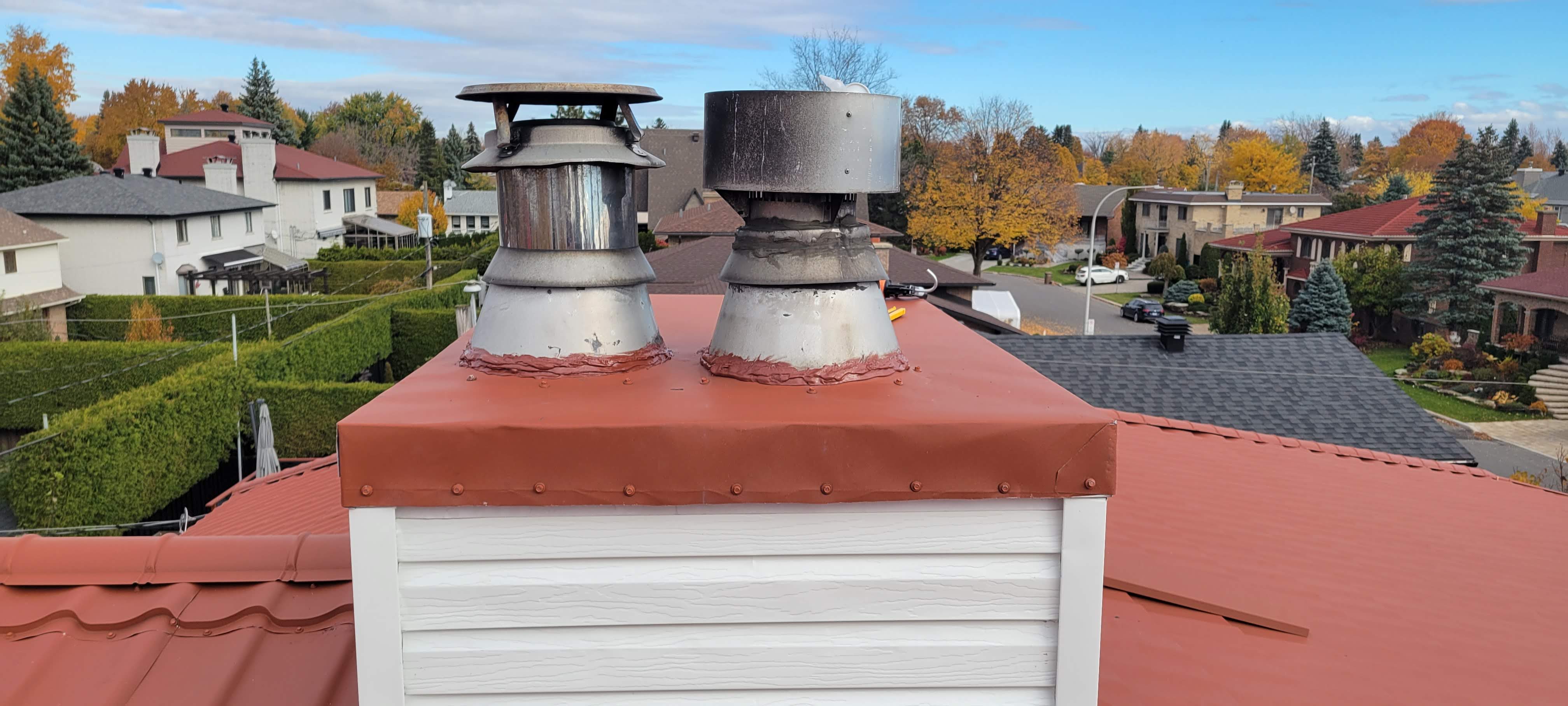 Metal roof chimney flashing repair on a residential roof in Montréal