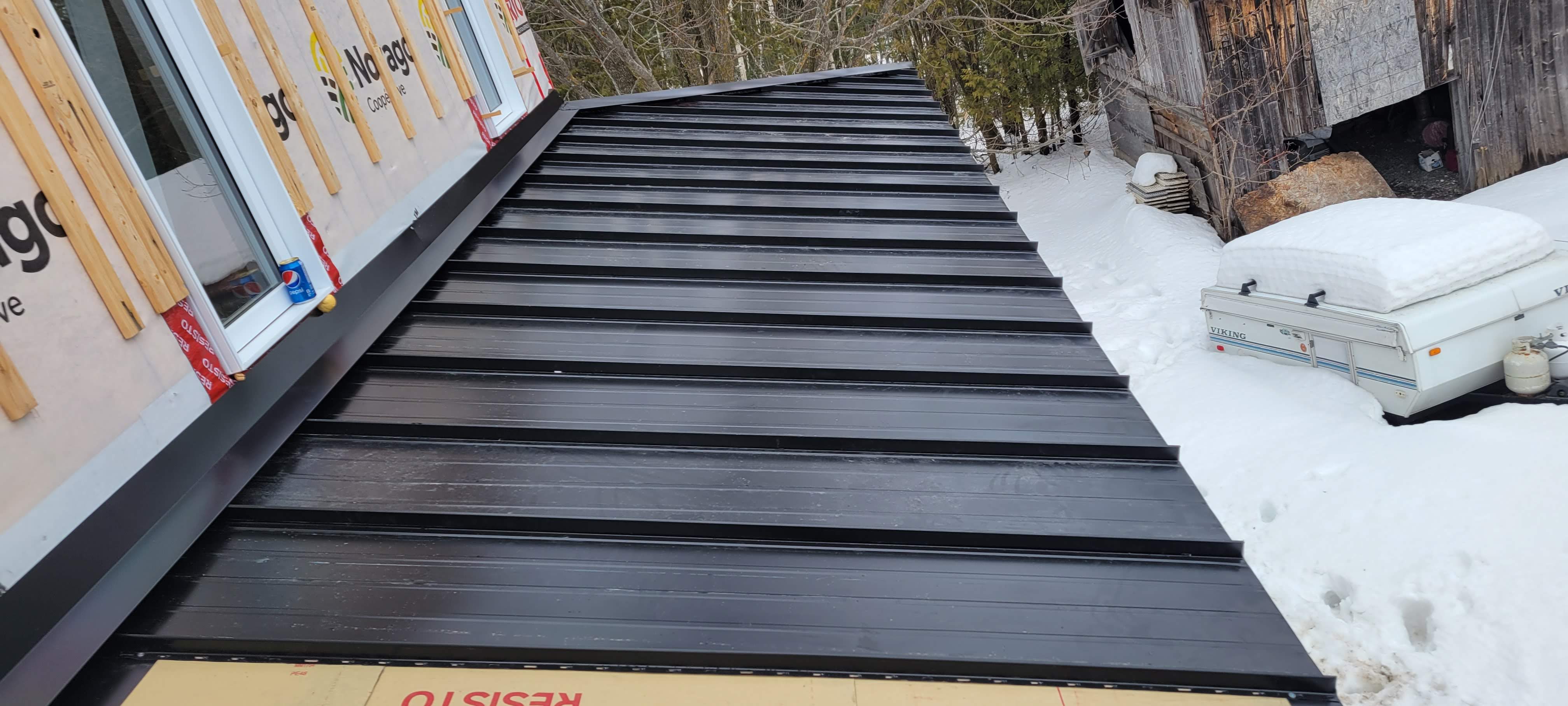 Close-up of black standing seam metal roof panels